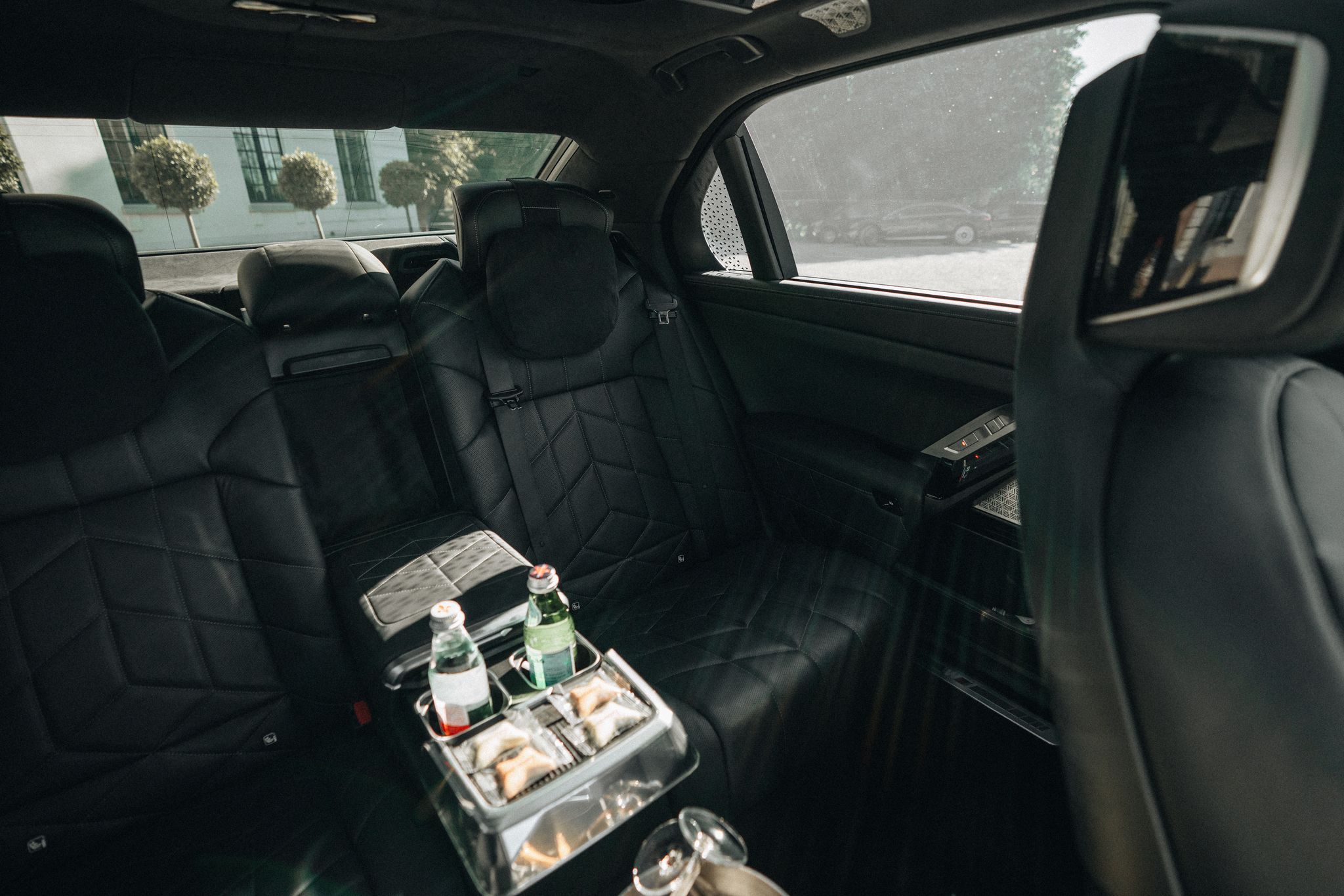 Rear cabin of the BMW i7, the LuxLimo Lux, with water and chocolate on board
