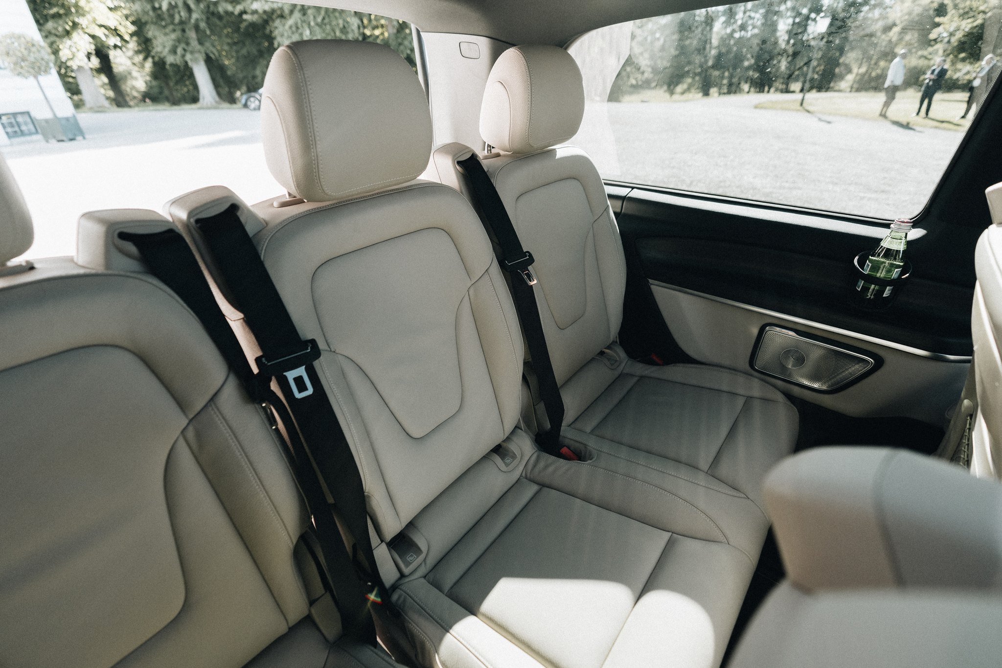 The rear bench of the Mercedes-Benz EQV VIP with the park outside