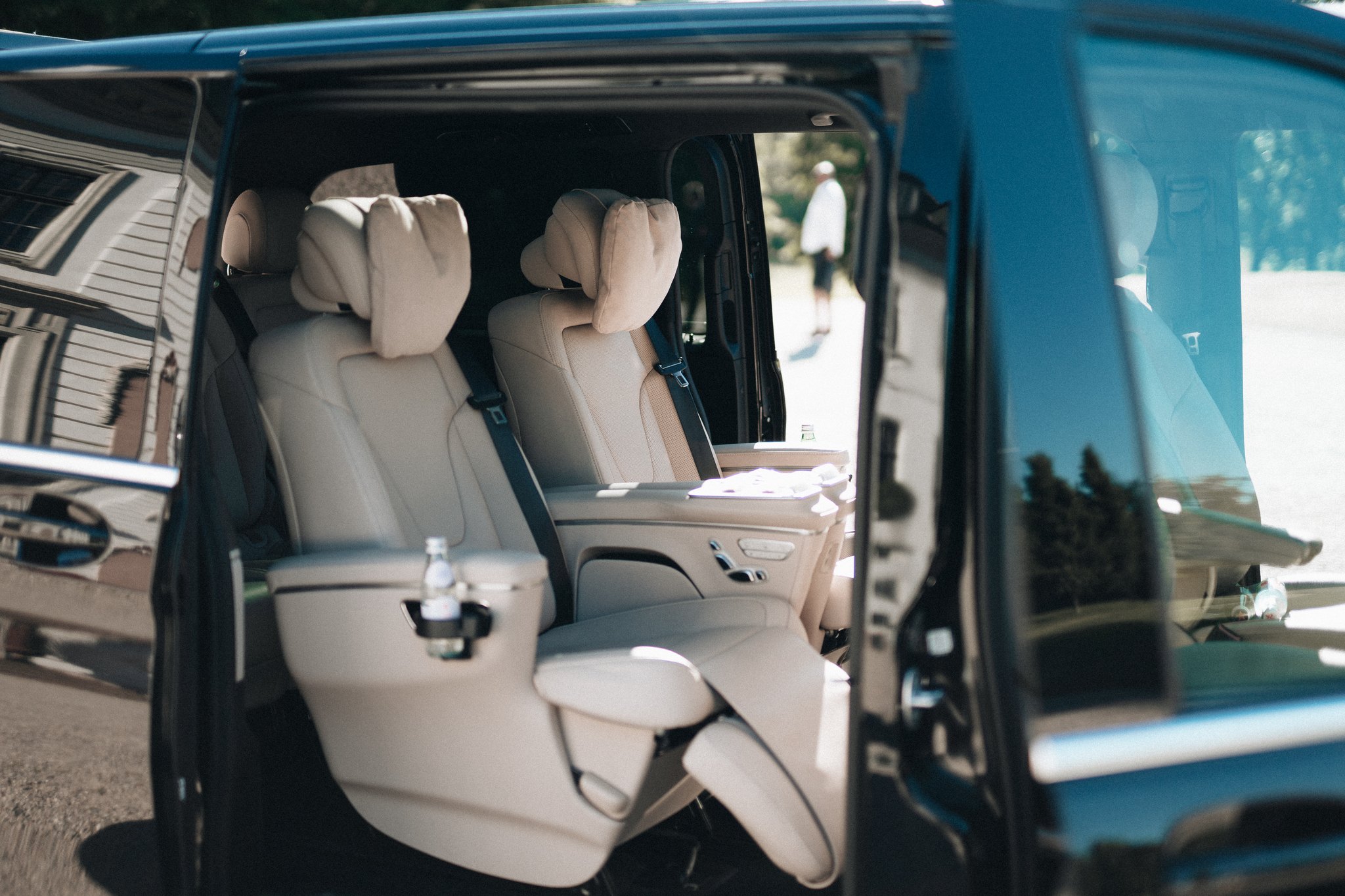 The open sliding door of the Mercedes-Benz EQV VIP with the lounge seats inside