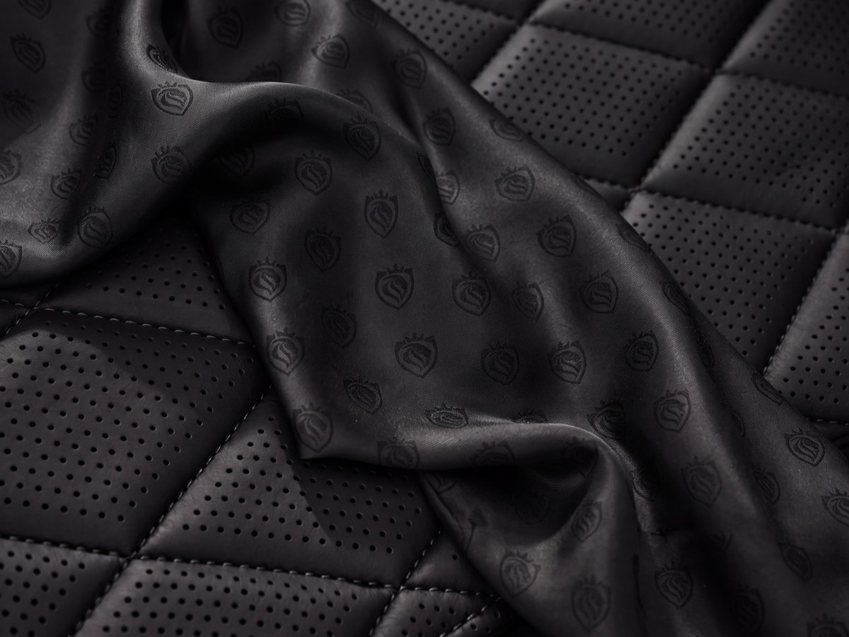 Quilted black leather interior of a LuxLimo chauffeur car