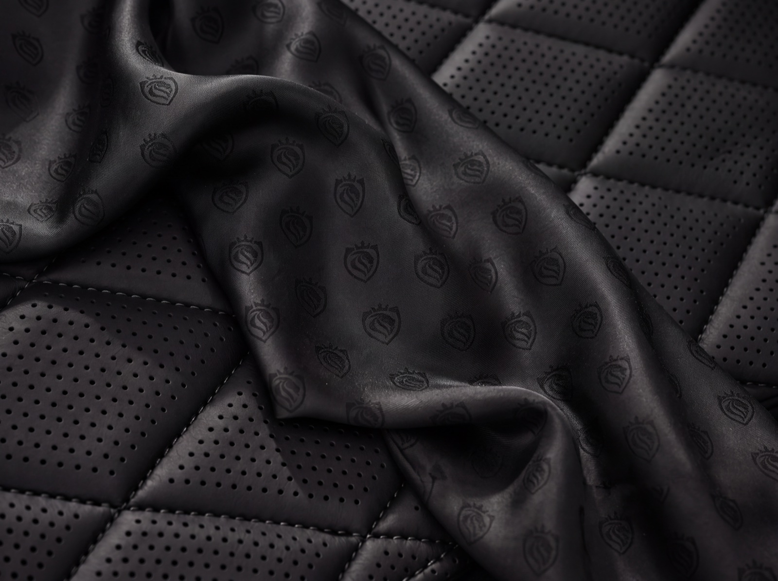 Quilted black leather interior of a LuxLimo chauffeur car