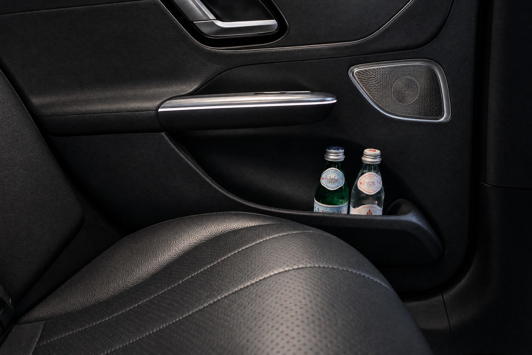 Two bottles of still water in the door pocket of the Mercedes-Benz EQE, the LuxLimo Business