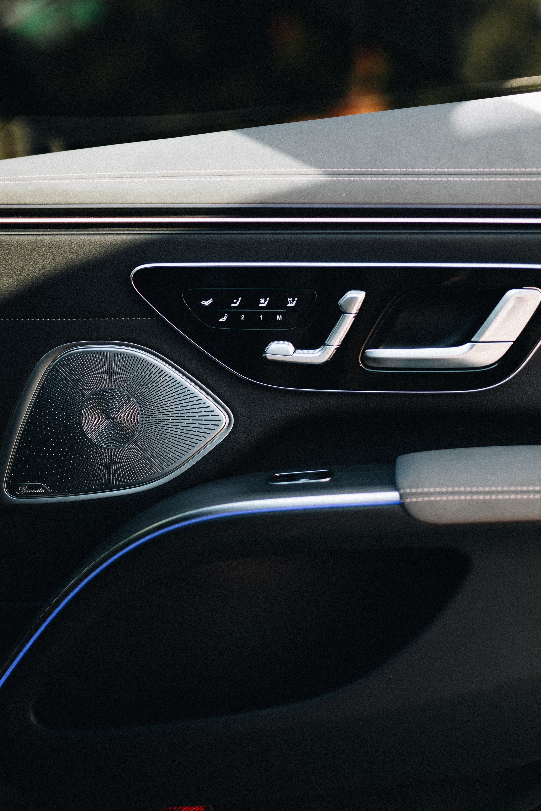 Door panel of the Mercedes-Benz EQS, the LuxLimo First, with seat controls, Burmester speaker and ambient light